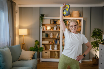 One mature caucasian woman training with kettlebell girya russian bell
