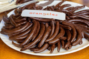 Sweet fruit candies in artisan Spanish confectionery shop, english translation: oranges