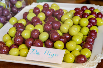 Sweet fruit candy beads in artisan Spanish confectionery shop, english translation: olives