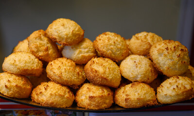 Fresh baked pastries and sweets on display in artisan Spanish confectionery shop, coconut cakes