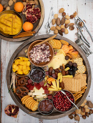 Cheese, crackers and fruit boards on wooden  table