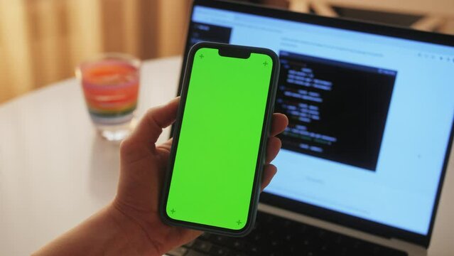 Phone with chroma key green screen with man working with chat gpt bot AI online, connecting with AI and using a chat GPT. IT engineer software developer programmer interact with