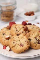 Cookies with freeze dried fruits and nuts on white table, closeup