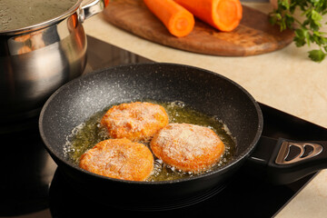 Cooking vegan cutlets in frying pan on stove