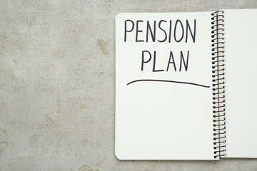 Notebook with words Pension Plan on light textured table, top view. Space for text