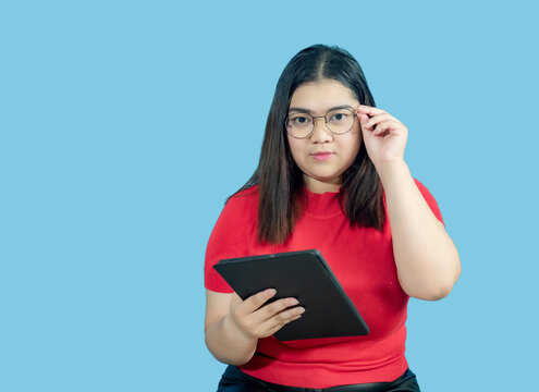 Portrait Business Girl Young Woman Asian Chubby Fat Cute Beautiful Pretty One Person Wearing Red Shirt In Office Holding Digital Tablet And Smiling Standing With Copy Space On Isolated Blue Blackgrond