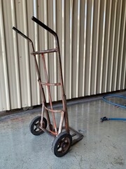wheelbarrow or trolley and water hose for clean