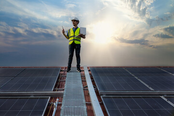 Engineer working setup Solar panel at the roof top. Engineer or worker work on solar panels or solar cells on the roof of business building