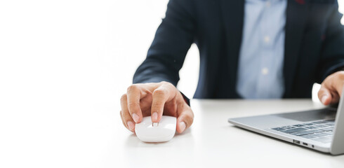 Close up of man hands typing on laptop and using mouse