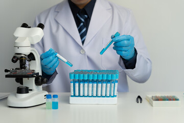 Research scientist or doctor looking at samples for research with test tubes doing research in clinical laboratory to test solution or drug in laboratory or panorama binoculars.