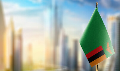 Small flags of the Zambia on an abstract blurry background
