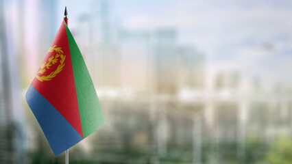 Small flags of the Eritrea on an abstract blurry background