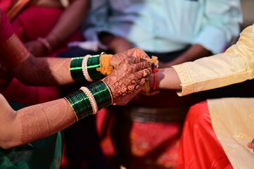 hands of indian wedding.Hindu Bride Wearing Turmeric Thread on a Groom hand. Kanyada  in Kanyadaan...