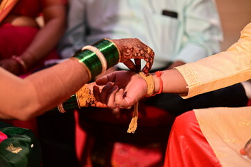 Kanyaadan Ceremony. Bride Wearing Turmeric Thread on a Groom hand. Marathi Wedding Ceremony....