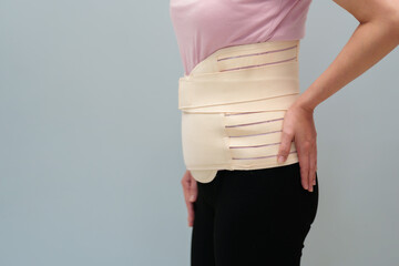 woman wearing lumbar support belts. pregnant and postnatal lumbar brace