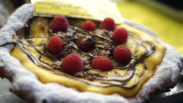 Langos Flatbread Topped With Chocolates And Raspberries - Dessert. - closeup