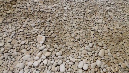 Rounded pebbles in the dry river bed