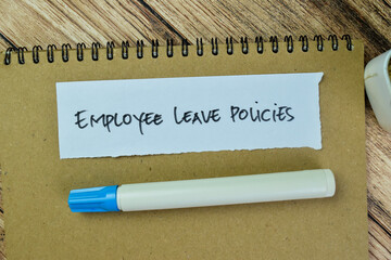 Concept of Employee Leave Policies write on sticky notes isolated on Wooden Table.