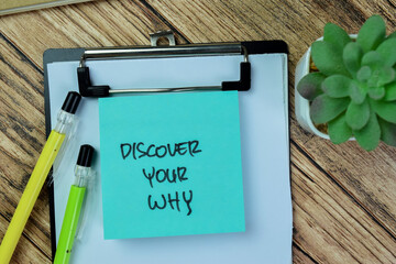 Concept of Discover Your Why write on sticky notes isolated on Wooden Table.