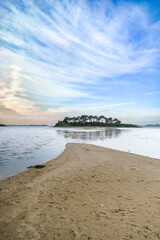 Brittany, the Morbihan gulf, view from the Ile aux Moines, seascape at low tide with an small island
