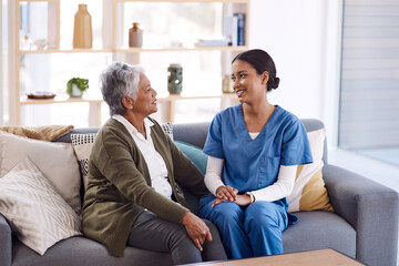 Healthcare, retirement and a nurse talking to an old woman on a sofa in the living room of a nursing home. Medical, trust and care with a female medicine professional chatting to a senior resident - obrazy, fototapety, plakaty