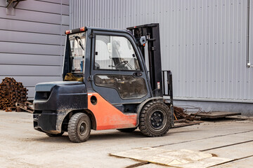 Forklift in a modern automatic warehouse or factory. Moving heavy loads in the enterprise. Warehousing, machines concept. Warehouse logistics. Modern loader