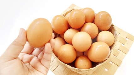 Eggs chicken fresh in wooden basket isolated on white background
