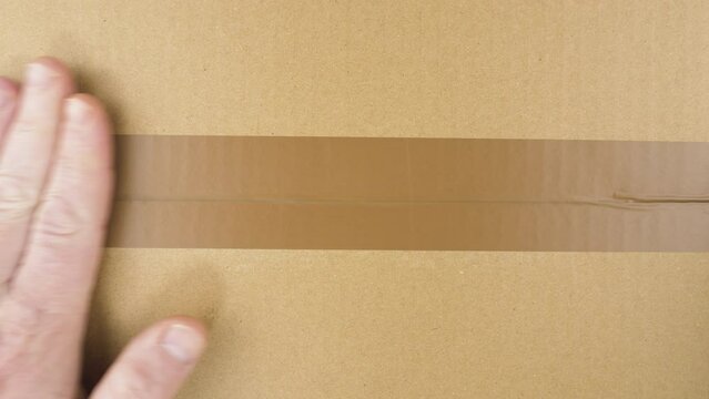 Sealing carton box. Closing cardboard box with chromakey inside.