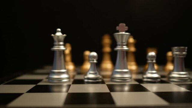Cinematic shot of human hands playing chess, moving figures across chessboard, chess game concept. 