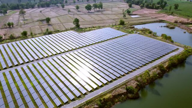 Solar electrical produce is infrastructure and modern technology. Photovoltaic solar cells farm industrial for renewable energy power.  Aerial view flying over vitality sustainable environment force.
