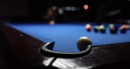 Player shots ball to push another item into pocket on billiard table. Successful shoot to win in tournament game. Entertainment and hobby