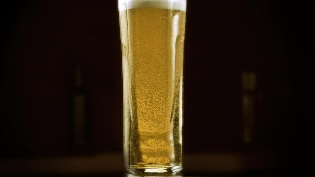 4K slow-motion glass of the golden elixir of craft IPA beer. Refreshing, delicious, and perfect for celebrating with friends at the bar. The unique taste of this artisanal creation.