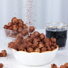 Coffee-flavored popcorn and cocoa-flavored popcorn, dark brown, on a table indoors, close-up