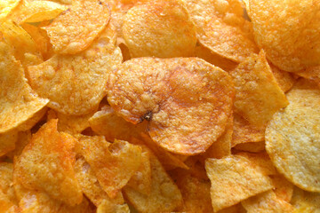 Potato chips texture background.  Spicy crispy sliced potatoes texture background.   