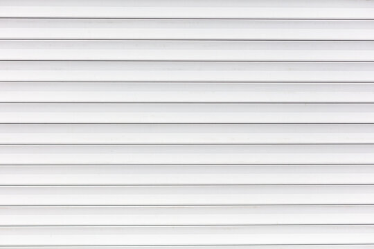 White metal roller shutter door texture background. Texture of white metal roller shutter door - Powered by Adobe