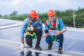 Male professional engineer installing solar photovoltaic panel system, Electrician mounting blue solar module technology on power industrial factory roof, Alternative energy ecological technician job