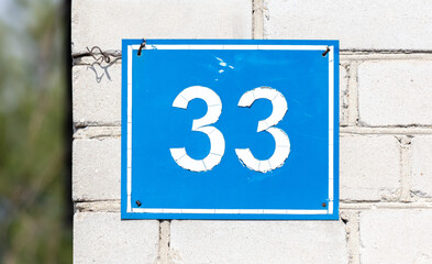 The number 33 on the plate of the house