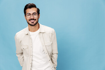 Portrait of a stylish man smile glasses for farsightedness and myopia, on a blue background in a white T-shirt, space space