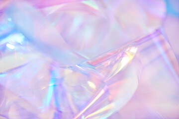 Close-up of ethereal pastel neon pink, purple, lavender, mint holographic metallic foil background....