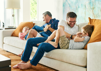 Gay parents, family fun and living room with dads and kids together with laugh and tickle. Parent...
