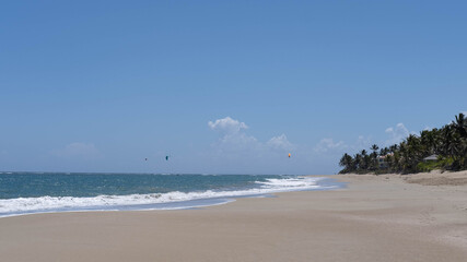 Tropical beach, turquoise sea water, ocean wave, yellow sand, green palm trees, sunny blue sky, white clouds, beautiful seascape, summer holidays, holidays on exotic islands, travel