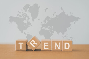 trend word on grunge wooden cube blocks with world map background, for monitoring new business