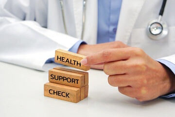 Hand holding a wooden block cube the top one with word and icon symbol. Medical and health concept.