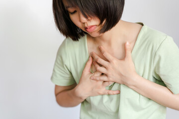 A woman has chest pain due to acute heart failure. Health care concept. - obrazy, fototapety, plakaty