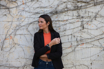 young beautiful woman leaning on a wall makes different expressions, sad, melancholic, happy, exhausted, dazed, smiling, thinking, tired. Concept different expressions.