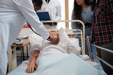 Medical students performing medical exam on dummy