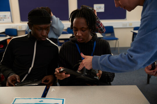 Teacher showing students equipment in class