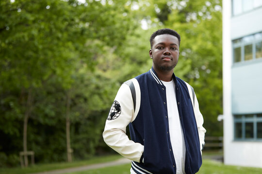 Portrait of young man in baseball jacket