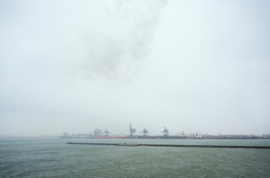 North Sea and Port of Rotterdam during storm with snowfall, Netherlands