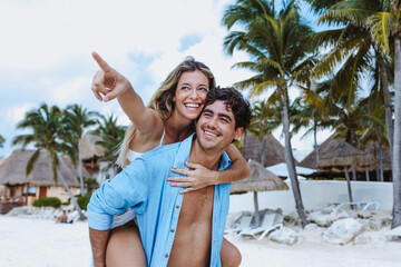 Hispanic young couple in love man and woman having fun on caribbean beach in holidays or vacations...